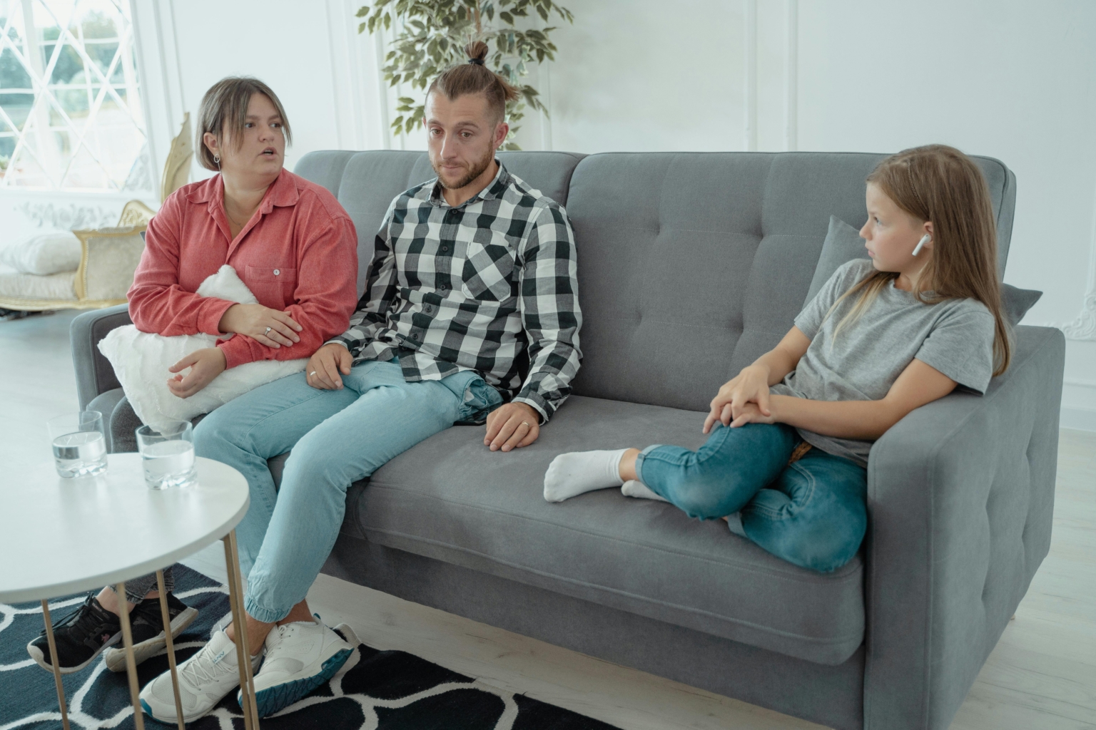 Couple and child seperated on sofa